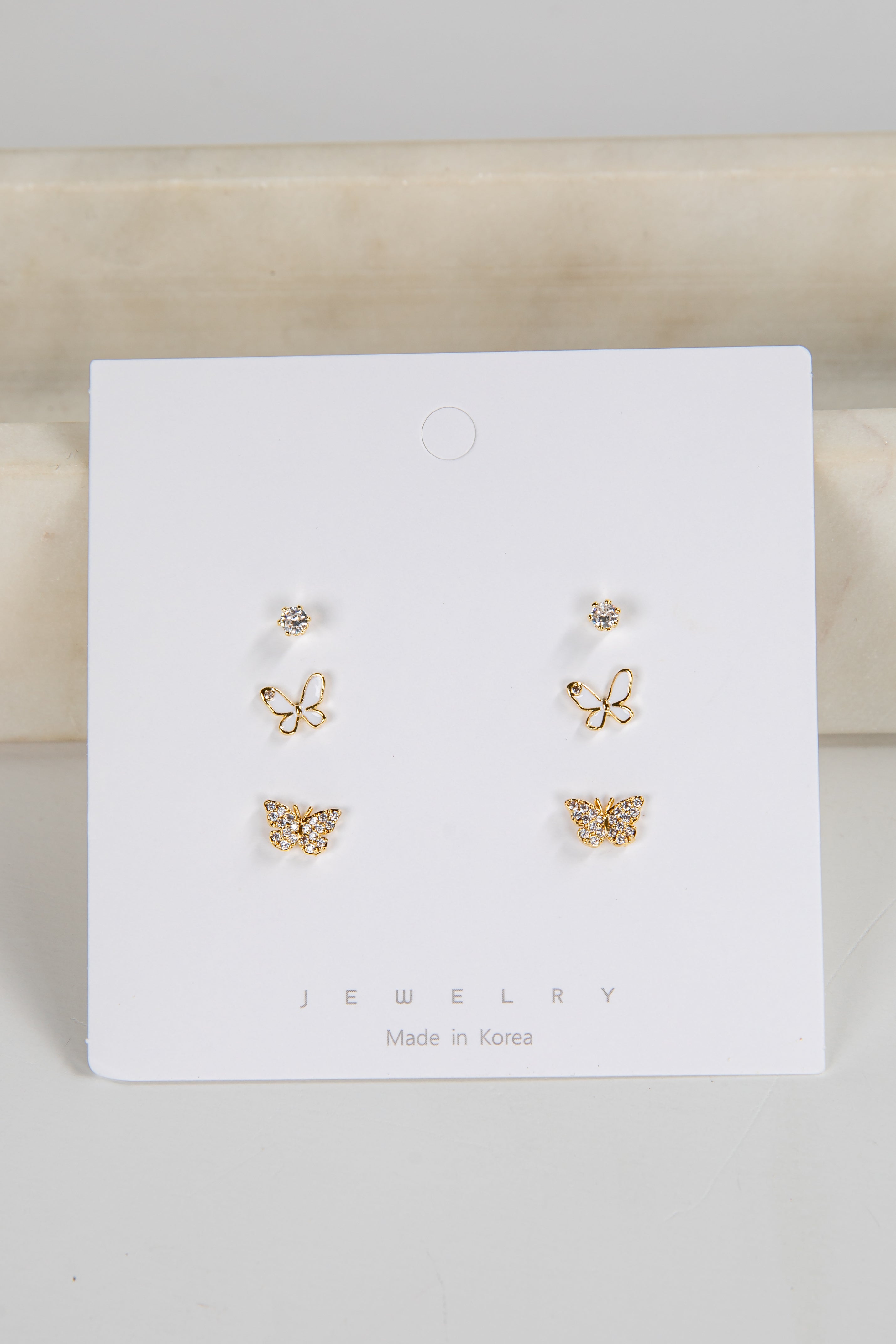 Set of butterfly-shaped earrings on a white card with 'Jewelry' text.