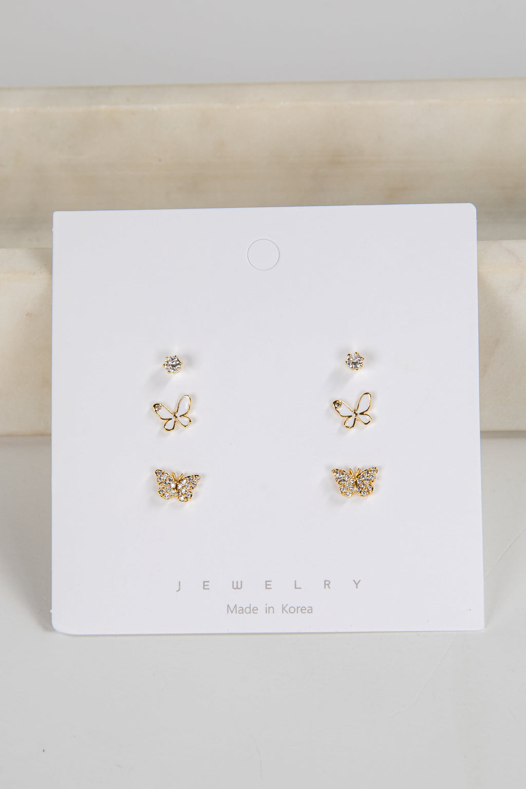 Set of butterfly-shaped earrings on a white card with 'Jewelry' text.